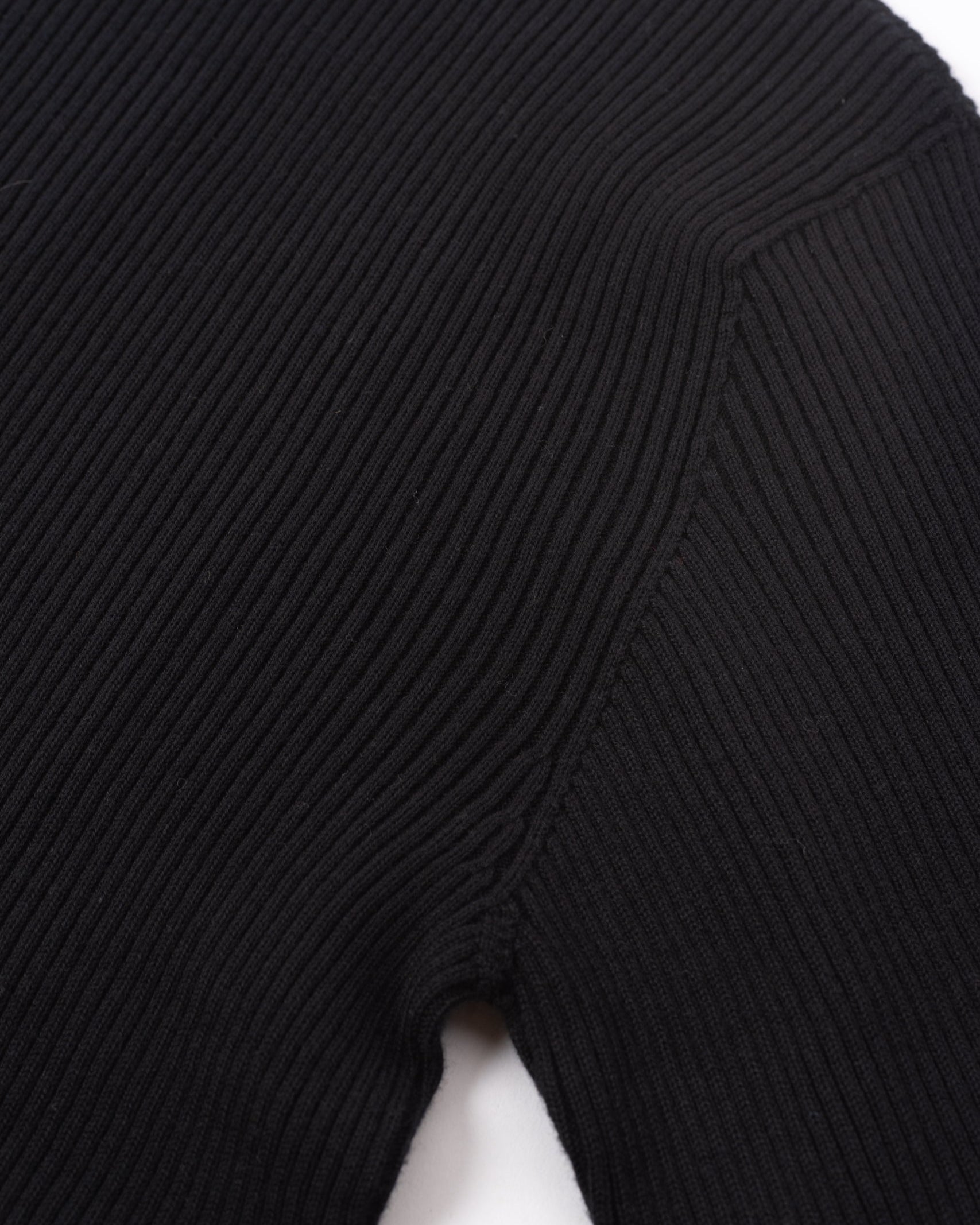 採用Cotton、Nylon、Silk 混紡的細緻紗線製成，材質帶有輕微絨面與溫潤的蠶絲光澤。使用2條紗線，採用15針Whole Garment針織機的規格織成，布料的設計採用羅紋織紋，追求彈性與柔順的垂墜表現。上衣的設計追求俐落、合身的輪廓，一體成型織出的上衣沒有經過縫製而平整無痕